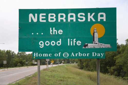 Sign for Nebraska featuring the phrase "the good life" and noting it as the "Home of Arbor Day."