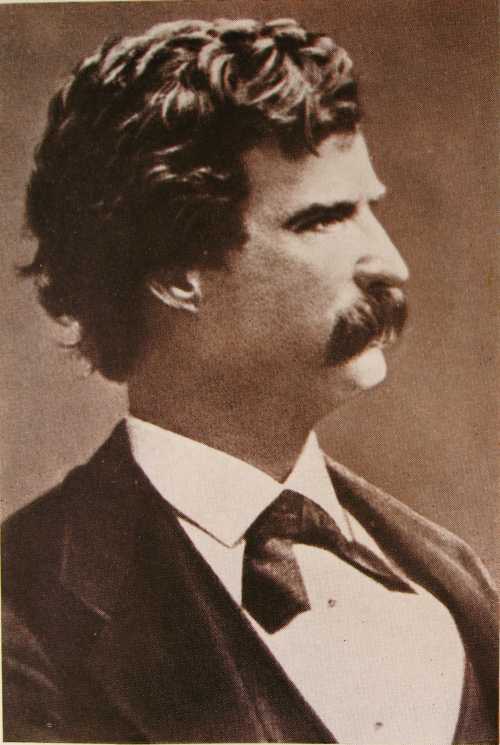 A vintage portrait of a man with curly hair and a mustache, dressed in a formal suit and bow tie.