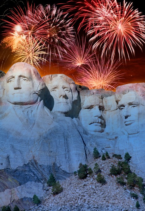 Mount Rushmore illuminated by colorful fireworks in the night sky, showcasing the iconic presidential sculptures.