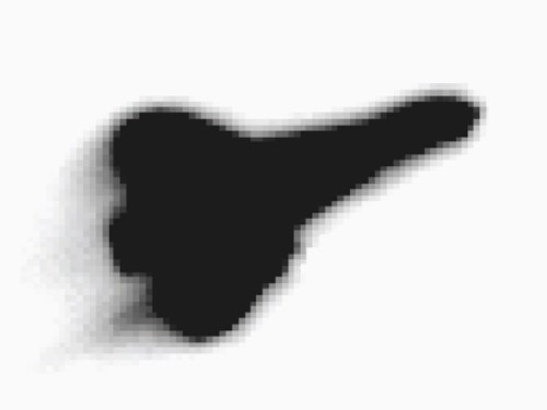 A blurred, abstract shape resembling a key or tool, predominantly black against a light background.