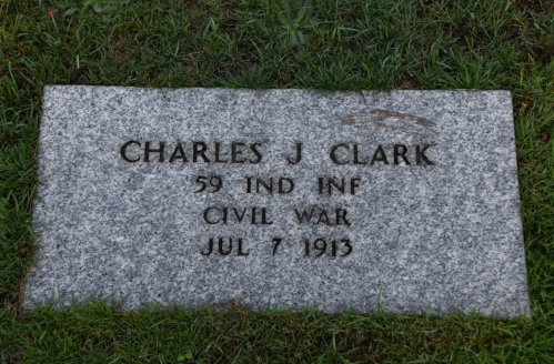 Gravestone of Charles J. Clark, 59th Indiana Infantry, Civil War, dated July 7, 1913, set in grass.