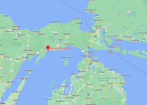 Map showing the area around Manistique, Michigan, highlighting nearby towns and bodies of water.