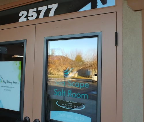 A storefront door with the text "Sea Scape Salt Room" and the address "2577" visible on the glass.
