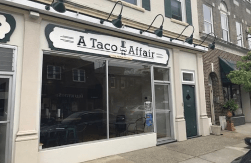 Exterior of "A Taco Affair" restaurant, featuring large windows and a welcoming entrance.