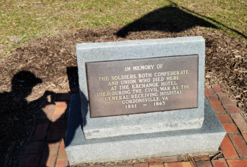 A stone memorial honoring soldiers from both the Confederate and Union sides who died at the Exchange Hotel during the Civil War.
