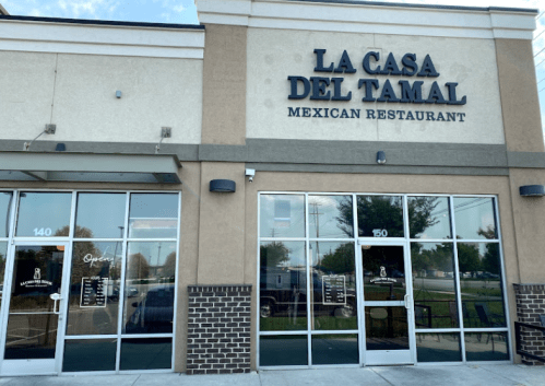 Exterior of "La Casa Del Tamal," a Mexican restaurant, featuring large windows and a welcoming entrance.