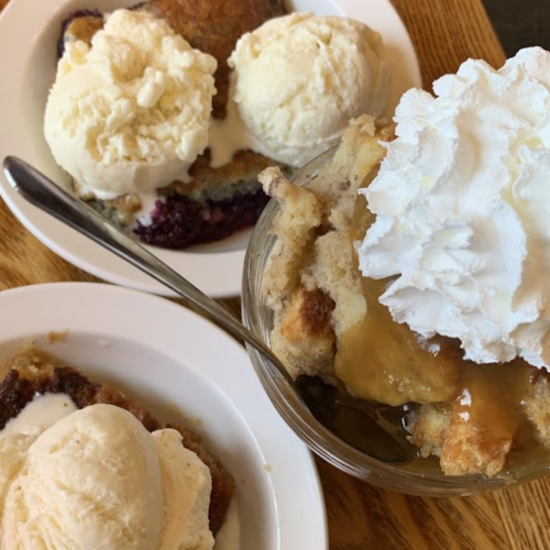 Three dessert dishes: one with ice cream on cake, another with ice cream, and a third with cake topped with whipped cream.