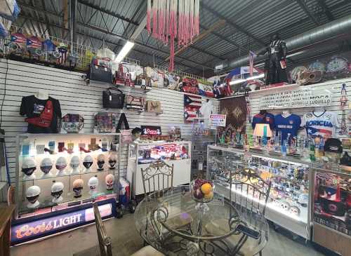 A vibrant display of collectibles and memorabilia in a shop, featuring various items on shelves and a glass table.