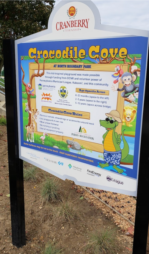 Sign for "Crocodile Cove" playground at North Boundary Park, detailing rules and features of the play area.