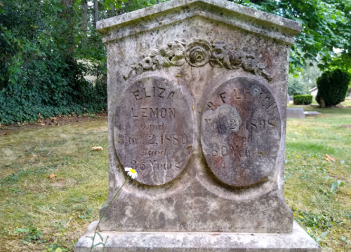 Weathered gravestone with inscriptions for Eliza Lemon (died 1880, aged 36) and R.F. Frits (died 1889, aged 60).