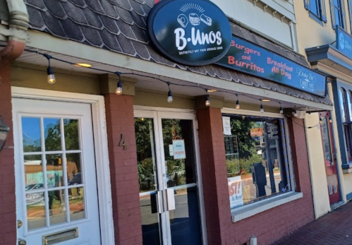 Exterior of B-Unos restaurant featuring a sign for burgers and burritos, with string lights and a welcoming entrance.