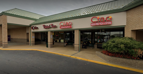Exterior of a restaurant with signs for "Ciao" and "Ciao Gelato," featuring a brick facade and green roof.