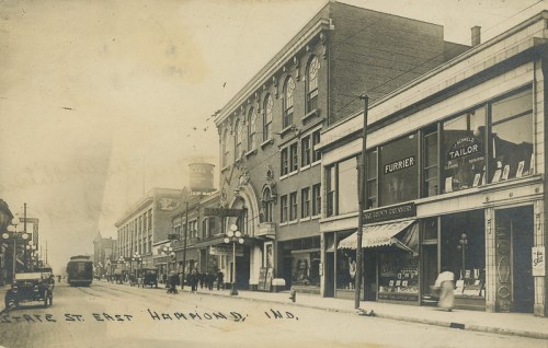 Historic black-and-white photo of East State Street in Hammond, Indiana, featuring shops and early 20th-century architecture.