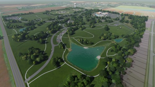Aerial view of a large park featuring green lawns, winding paths, ponds, and surrounding fields.
