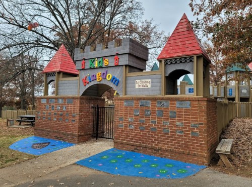 Colorful entrance to a playground called "Kids Kingdom," featuring castle-like towers and a gated entry.