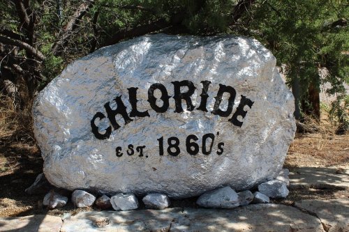 A large, silver-painted rock with the word "Chloride" and "est. 1860s" inscribed in bold black letters.