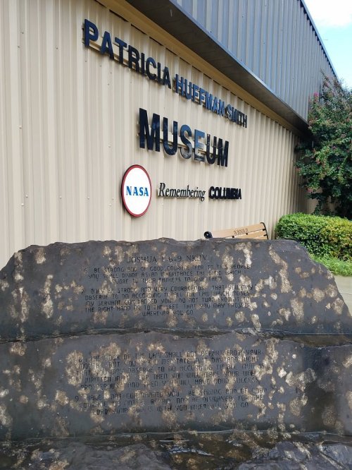 Exterior of the Patricia Huffman Smith Museum, featuring a memorial stone for Joshua L. McGowan and NASA's Columbia.