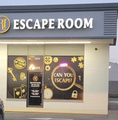 Exterior of an escape room building with a sign that reads "ESCAPE ROOM" and a neon "OPEN" sign.