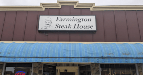Sign for Farmington Steak House with a blue awning and "OPEN" sign in the window.