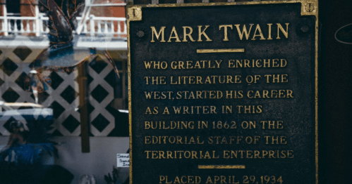 Plaque honoring Mark Twain, noting his contributions to literature and his career start in this building in 1862.