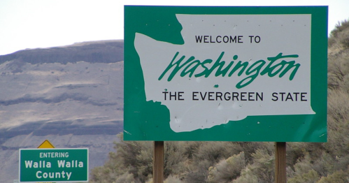 Welcome sign for Washington, the Evergreen State, with a map outline and a smaller sign for Walla Walla County.