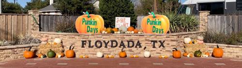 A festive display in Floydada, TX, featuring large pumpkins and autumn decorations for "Punkin Days."