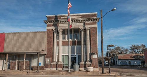 Stately brick building as seen from Italy, Texas.
