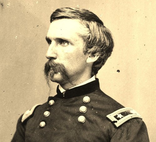 Portrait of a 19th-century military officer in uniform, featuring a prominent mustache and shoulder insignia.
