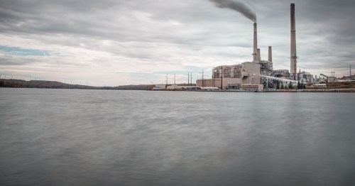 Mount Storm Power Station sitting on the edge of Mount Storm Lake under a cloudy, gray sky in West Virginia.