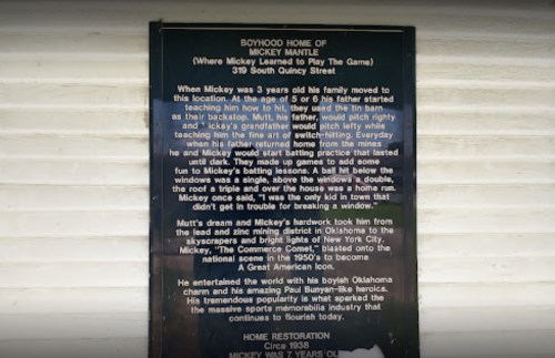 Plaque detailing Mickey Mantle's childhood home and his early baseball influences at 319 South Quincy Street.