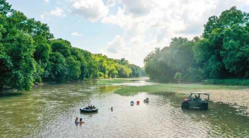 A serene river scene with people swimming and relaxing, surrounded by lush green trees and a vehicle parked nearby.