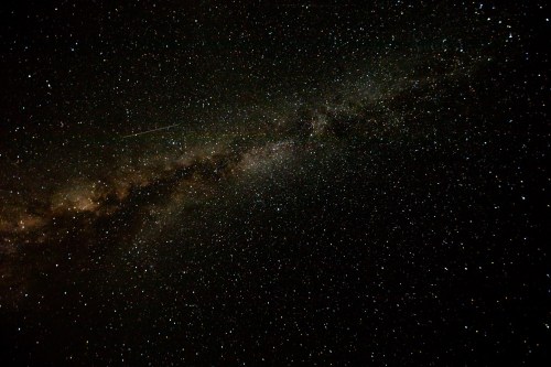 A stunning view of a starry night sky with a bright band of the Milky Way galaxy and scattered stars.