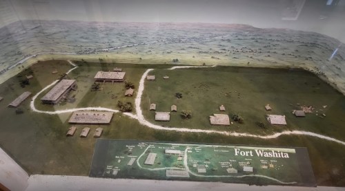 Model of Fort Washita, showcasing buildings and landscape in a historical setting.