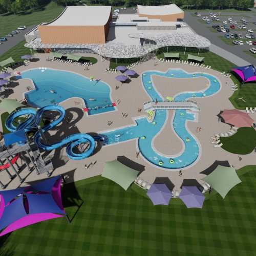Aerial view of a water park featuring pools, slides, and shaded areas with lounge chairs. Green lawn surrounds the area.