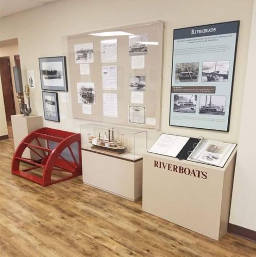 Exhibit showcasing riverboat history with displays, artifacts, and informational panels in a museum setting.