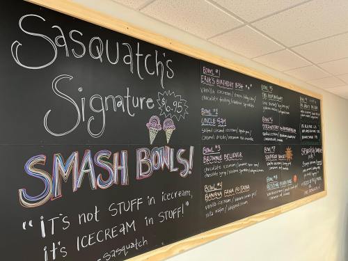 Chalkboard menu featuring "Sasquatch's Signature" ice cream bowls and flavors, with prices and playful descriptions.