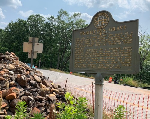 A historical marker for Trahlyta's Grave, with a pile of stones nearby, located near Cedar Mountain.