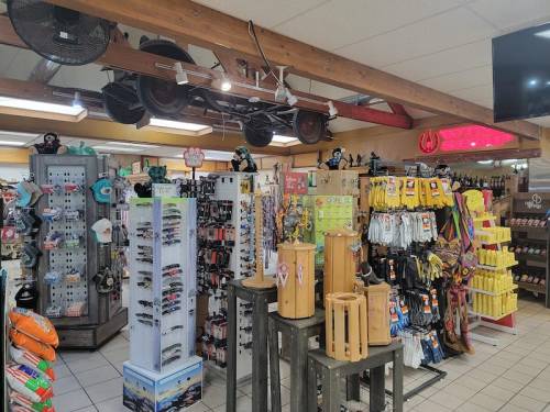 A colorful retail store interior featuring various merchandise displays, including accessories and outdoor gear.