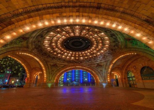 A beautifully lit architectural dome with intricate designs and colorful lights, creating a vibrant atmosphere.