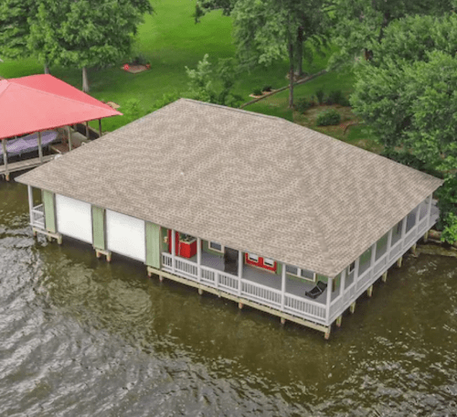 Aerial view of a lakeside pavilion with a gray roof, surrounded by water and greenery.