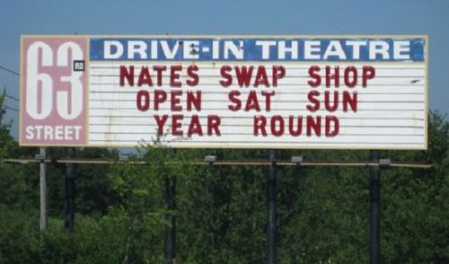 Sign for a drive-in theater advertising "Nate's Swap Shop," open Saturday and Sunday year-round.