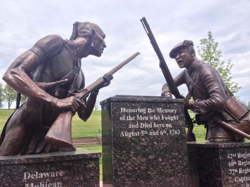 Statues of a Native American and a soldier, honoring those who fought and died on August 5-6, 1763.