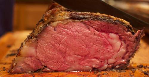 Close-up of a perfectly cooked roast beef, showcasing its juicy pink interior and crispy outer crust.