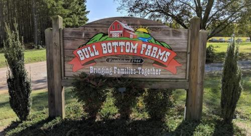 Sign for Bull Bottom Farms, established 1944, featuring a red barn and the slogan "Bringing Families Together."