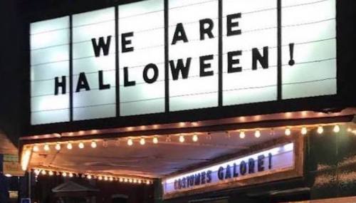 A marquee sign reads "WE ARE HALLOWEEN!" with lights and decorations, promoting a festive atmosphere.