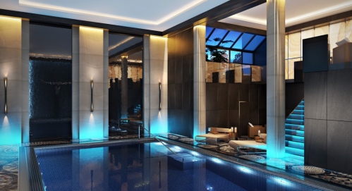 Luxurious indoor pool area with modern design, ambient lighting, and elegant seating.