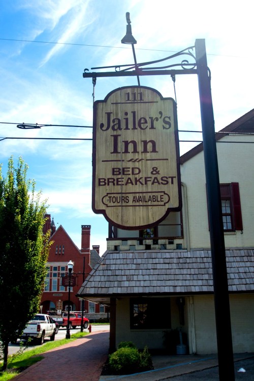 Sign for Jailer’s Inn Bed & Breakfast, featuring "Tours Available," with a clear blue sky in the background.