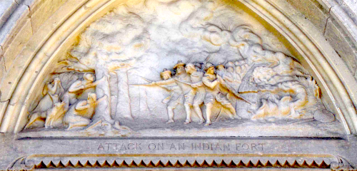 Relief sculpture depicting an attack on an Indian fort, featuring soldiers and smoke in a dramatic scene.