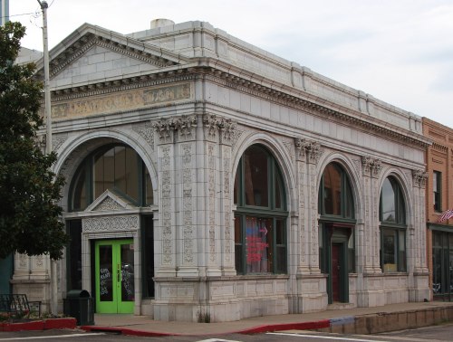 Historic building with ornate architecture, featuring large arched windows and a decorative facade.