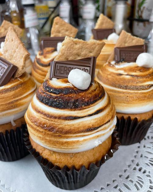 Delicious cupcakes topped with toasted meringue, chocolate, graham cracker, and a mini marshmallow.